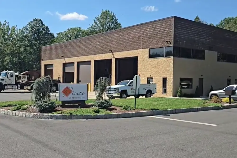 The Pinto of Montville office and truck garage, with the company sign at the entrance