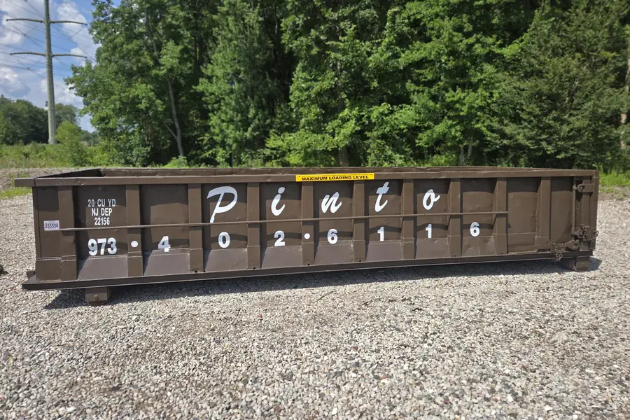 A Pinto of Montville 20-yard roll-off dumpster, seen from the side