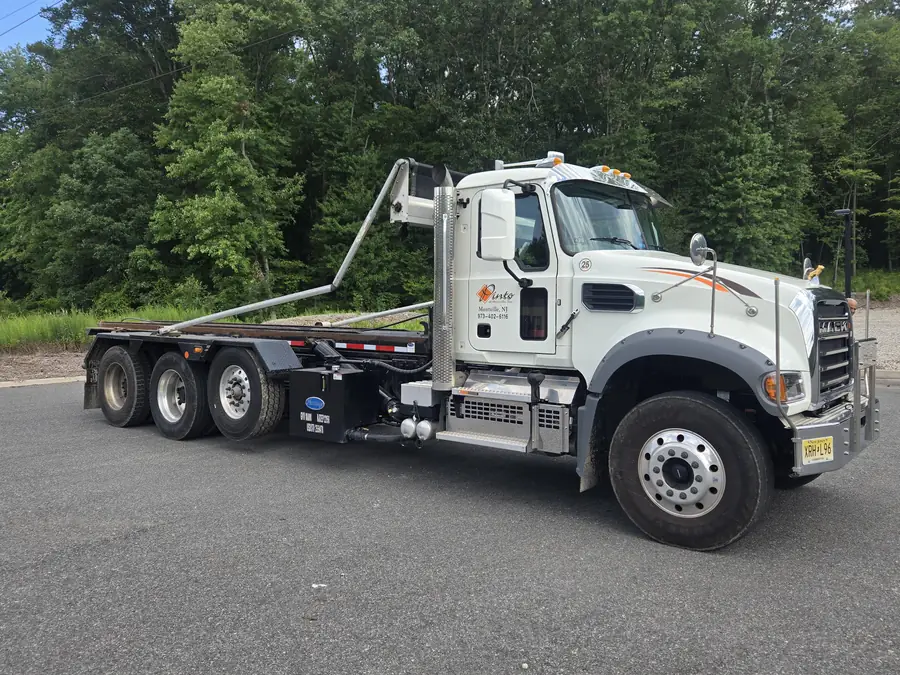 A Pinto of Montville roll-off truck with its hoist empty